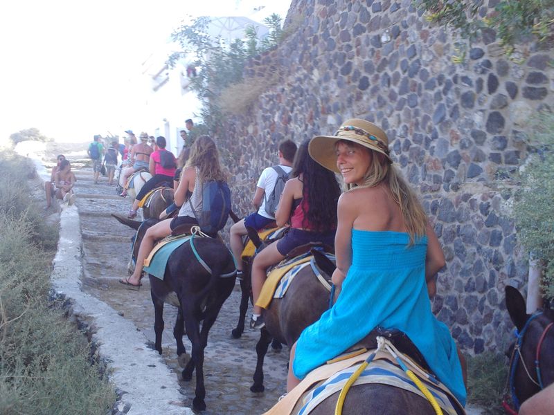 Riding donkeys on the way upstairs to Oia, Santorini