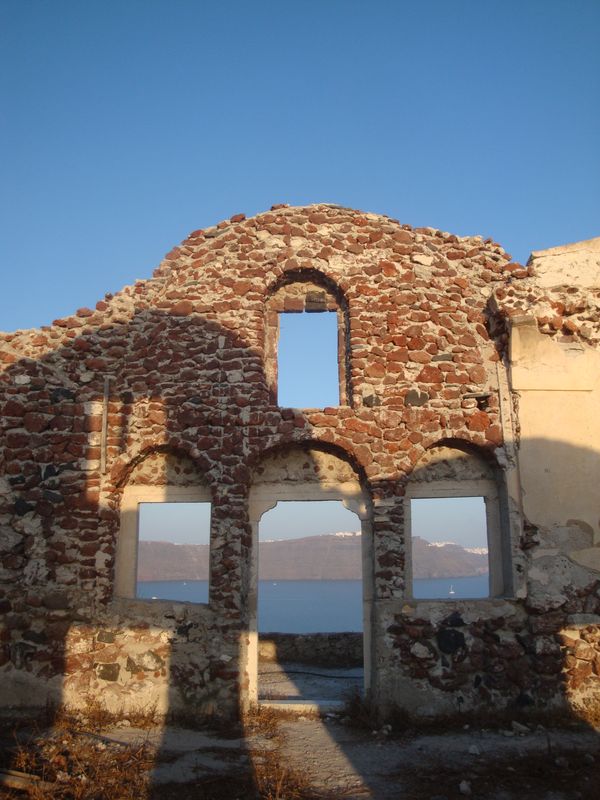 An ancient wall in the rays of sunset. Oia, Santorini