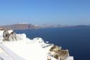 21. Breathtaking view with a spinning wheel - Oia, Santorini